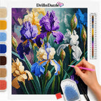 A diamond painting or cross-stitch style floral artwork sheet showing iris flowers, with a hand holding a pink tool and a color list printed on the right. The brand name DrillnDazzle appears at the top, and paint palette swatches are shown along the left side.