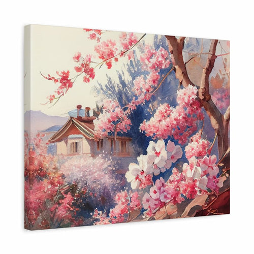 A square canvas wall art print depicting a soft, impressionistic landscape with pink and white blossoms, tree branches, a small house, and blue-purple foliage. The canvas is shown at a slight angle against a plain white background.