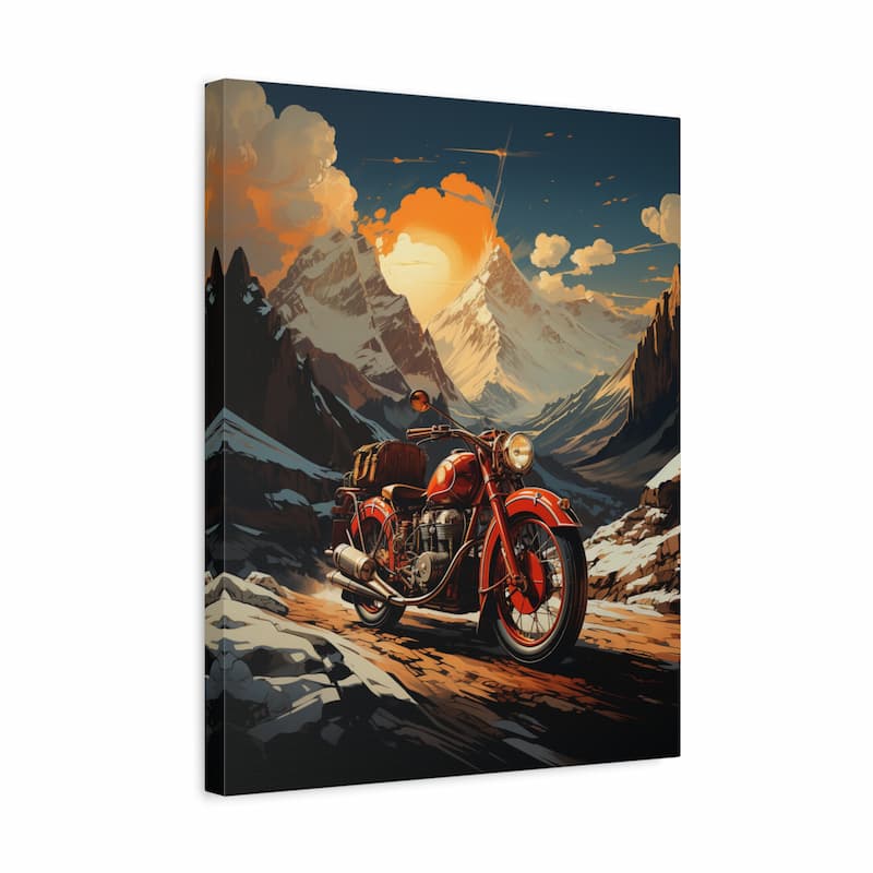 A rectangular canvas wall art print showing a red motorcycle traveling through a dramatic mountain landscape at sunset, photographed against a plain white background.