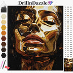 DrillnDazzle diamond painting kit featuring a close-up portrait of a woman's face in gold, brown, and black tones. The image includes a color palette strip on the left, a symbol reference chart on the right, and small paintbrushes and a paint palette at the bottom left.
