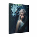 A vertical canvas wall art print featuring a fantasy portrait of a pale woman with long white hair beside a large blue-gray dragon in a dark forest. The canvas is shown at a slight angle against a plain white background.