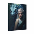 A vertical canvas wall art print featuring a fantasy portrait of a pale woman with long white hair beside a large blue-gray dragon in a dark forest. The canvas is shown at a slight angle against a plain white background.