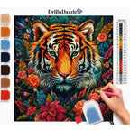 A diamond painting kit showing a completed tiger and floral artwork, with a hand holding a paint brush on the right, a color chart on the right side, and color swatches on the left. The brand name DrillnDazzle is visible at the top.