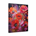 A square canvas wall art print featuring a vivid floral design with large poppy-like flowers in red, orange, pink, and purple tones against a dark background, shown at a slight angle on a white studio background.