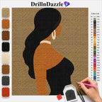 A diamond painting kit design featuring a woman's silhouette with long black hair, wearing a black top and white hoop earrings, on a tan grid canvas. The image includes a color list on the right and color swatches on the left, with a hand holding a pink pen working on the canvas.