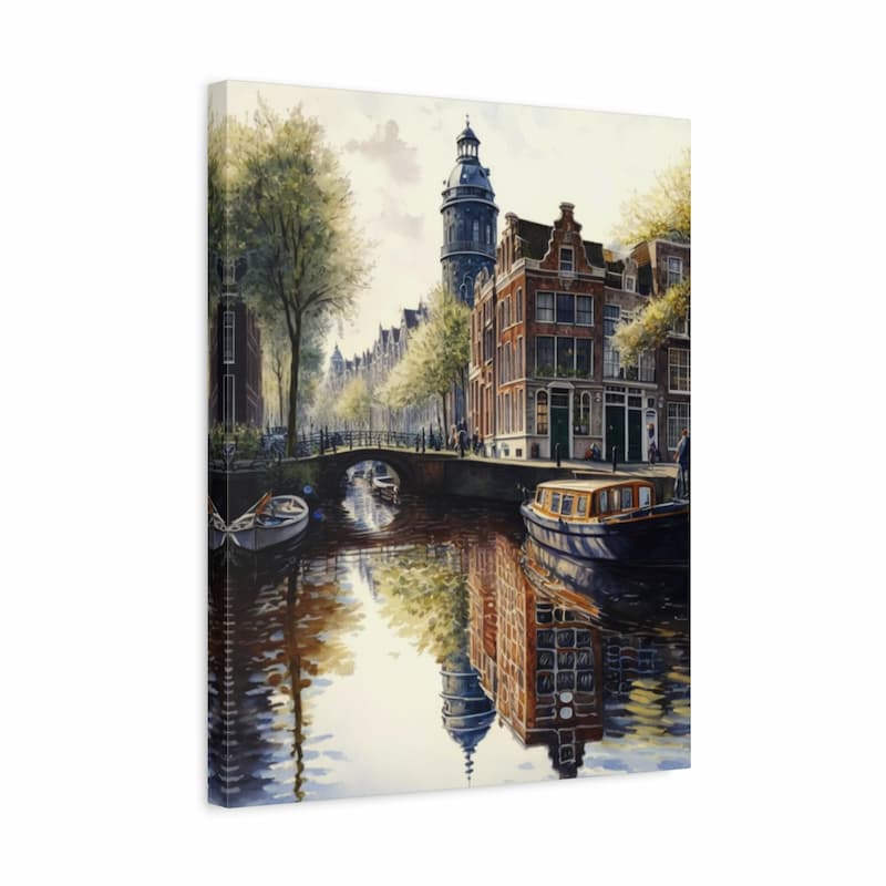 A vertical canvas wall art print depicting a scenic Amsterdam canal with historic brick buildings, trees, a bridge, boats, and reflections in the water, shown at a slight angle against a white background.