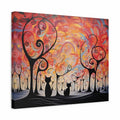 A square canvas wall art print featuring an abstract landscape with swirling orange, red, yellow, and pink sky, black stylized trees, and black cat silhouettes along the bottom, shown at a slight angle on a white background.