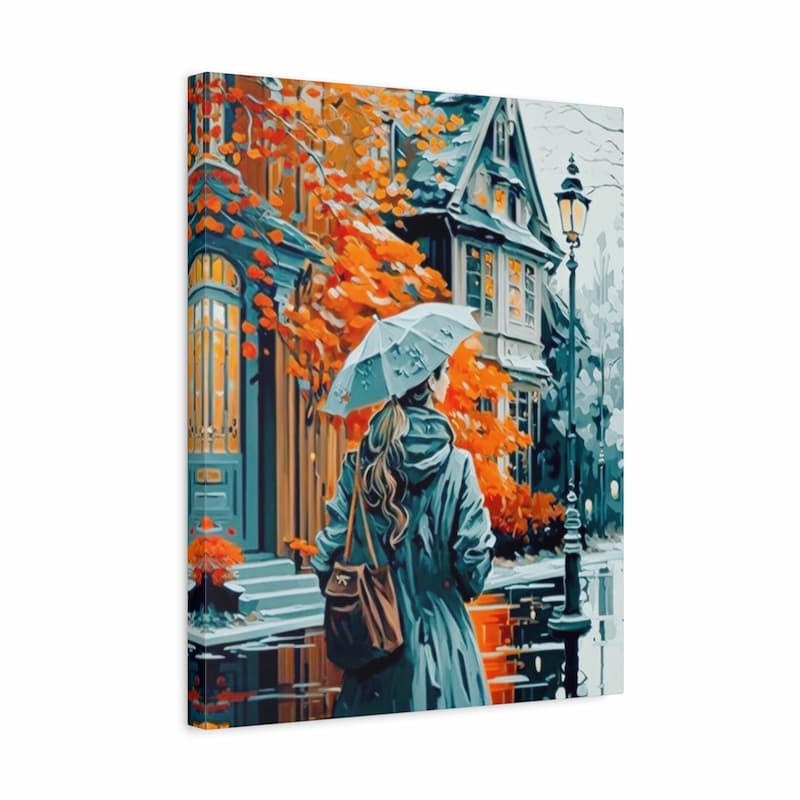 A vertical canvas print featuring an artistic depiction of a woman in a teal raincoat holding a light blue umbrella on a snowy city street with orange autumn leaves and blue houses.
