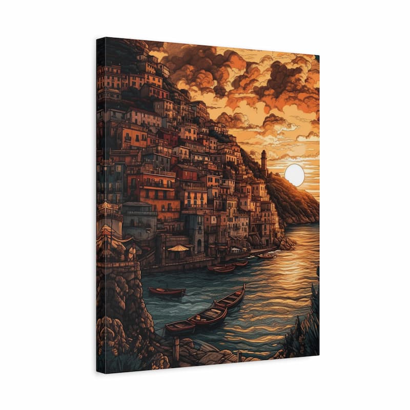 A vertical canvas wall art print depicting a scenic coastal town at sunset, with layered buildings on a hillside, boats on the water, and dramatic orange clouds. The canvas is shown at a slight angle against a plain white background.