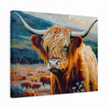 A square canvas wall art print depicting a close-up portrait of a Highland cow with long horns, set in a grassy field with mountains in the background. The canvas is shown at an angle against a plain white background.