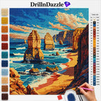 A diamond painting kit preview showing a completed coastal landscape design with sea stacks, cliffs, and blue ocean under a cloudy sky. The image includes a color list on the right and a vertical row of color swatches on the left.