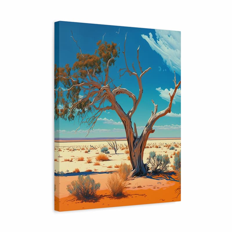A vertical canvas wall art print depicting a stylized desert landscape with a large gnarled tree, orange sand, sparse shrubs, and a bright blue sky with white clouds, shown at a slight angle against a white background.