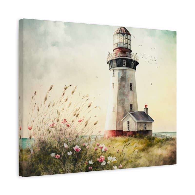 A square canvas wall art print depicting a lighthouse beside a small house, with tall grasses and pink flowers in the foreground under a pale sky. The canvas is shown at a slight angle against a plain white background.