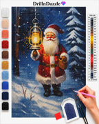A diamond painting kit design featuring Santa Claus holding a glowing lantern in a snowy night forest. The image shows the completed canvas artwork, a color reference chart on the right, a vertical row of paint swatches on the left, and a hand holding a pink paint pen at the bottom right.