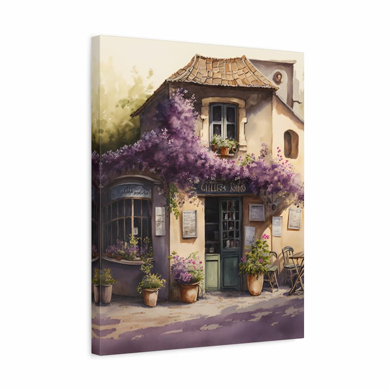 A vertical canvas wall art print depicting a charming European-style building with a tiled roof, purple flowering vines, potted plants, and a green door, shown at a slight angle against a white background.