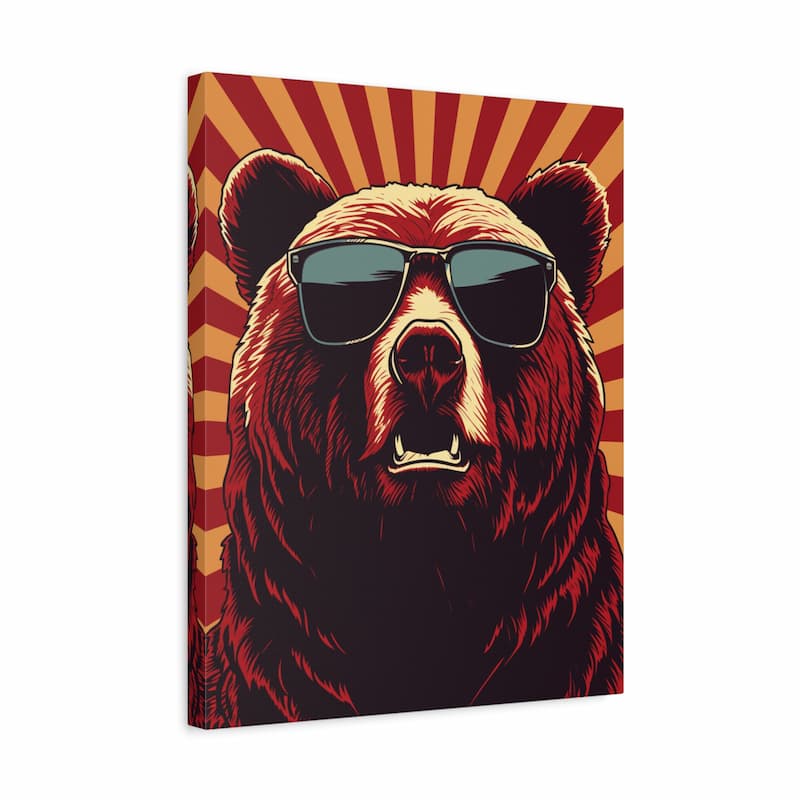 A square canvas wall art print featuring a stylized brown bear wearing black sunglasses against a red and orange sunburst background, shown at a slight angle on a white studio background.