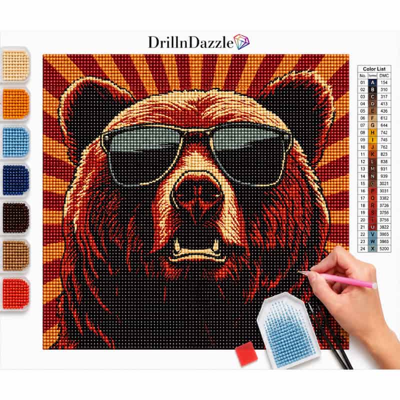 A diamond painting kit showing a completed bear portrait with sunglasses, a color list chart, a paint palette, and a hand holding a pink drill pen working on the project. The brand name 'DrillnDazzle' is visible at the top.