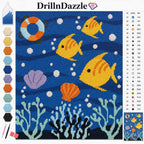 A diamond painting canvas design titled 'DrillnDazzle' featuring an underwater ocean scene with yellow fish, orange seashells, a white and blue life preserver, and coral on a deep blue background. The left side shows a color selection chart with various paint swatches, and the right side displays a numbered color legend.