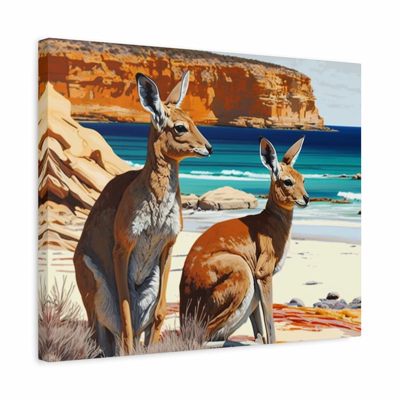A square canvas wall art print depicting two brown kangaroos on a sandy beach with turquoise water and orange rock cliffs in the background, shown at a slight angle against a white studio backdrop.