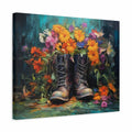 A square canvas wall art print showing a pair of dark brown lace-up boots surrounded by a colorful bouquet of orange, yellow, pink, and purple flowers against a dark teal and black painted background.