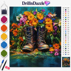 A diamond painting or cross-stitch style craft kit preview featuring a colorful floral bouquet and a pair of brown lace-up boots on a teal background. The image includes the DrillnDazzle brand logo, a color palette strip on the left, a numbered color reference chart on the right, and two paint pens at the bottom left.