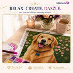 A diamond painting canvas featuring a golden retriever dog in a flower field, displayed on a wooden table with a lit candle, flowers, a mug, and small paint beads. The brand name DrillinDazzle is visible at the top and on the canvas header.
