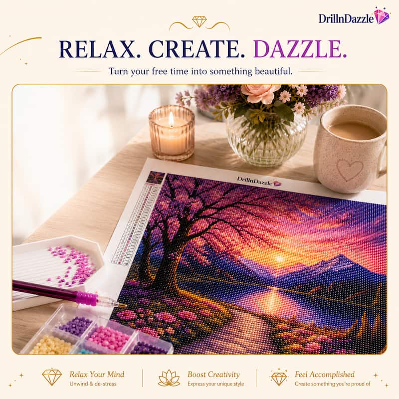 A DrillnDazzle diamond painting kit showing a completed landscape print of a sunset over a mountain lake, surrounded by craft supplies including a paint pen, color trays, and a mug on a wooden table.
