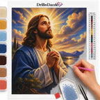 A diamond painting kit sheet featuring an illustration of Jesus with hands clasped, surrounded by a colorful sky and clouds. The left side shows rows of colored beads, and a hand holds a pink needle tool on the right.